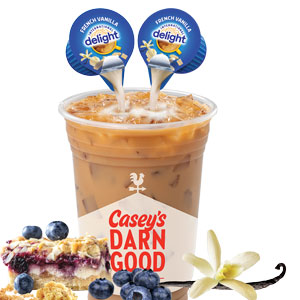 vanilla creamer being poured into a coffee cup