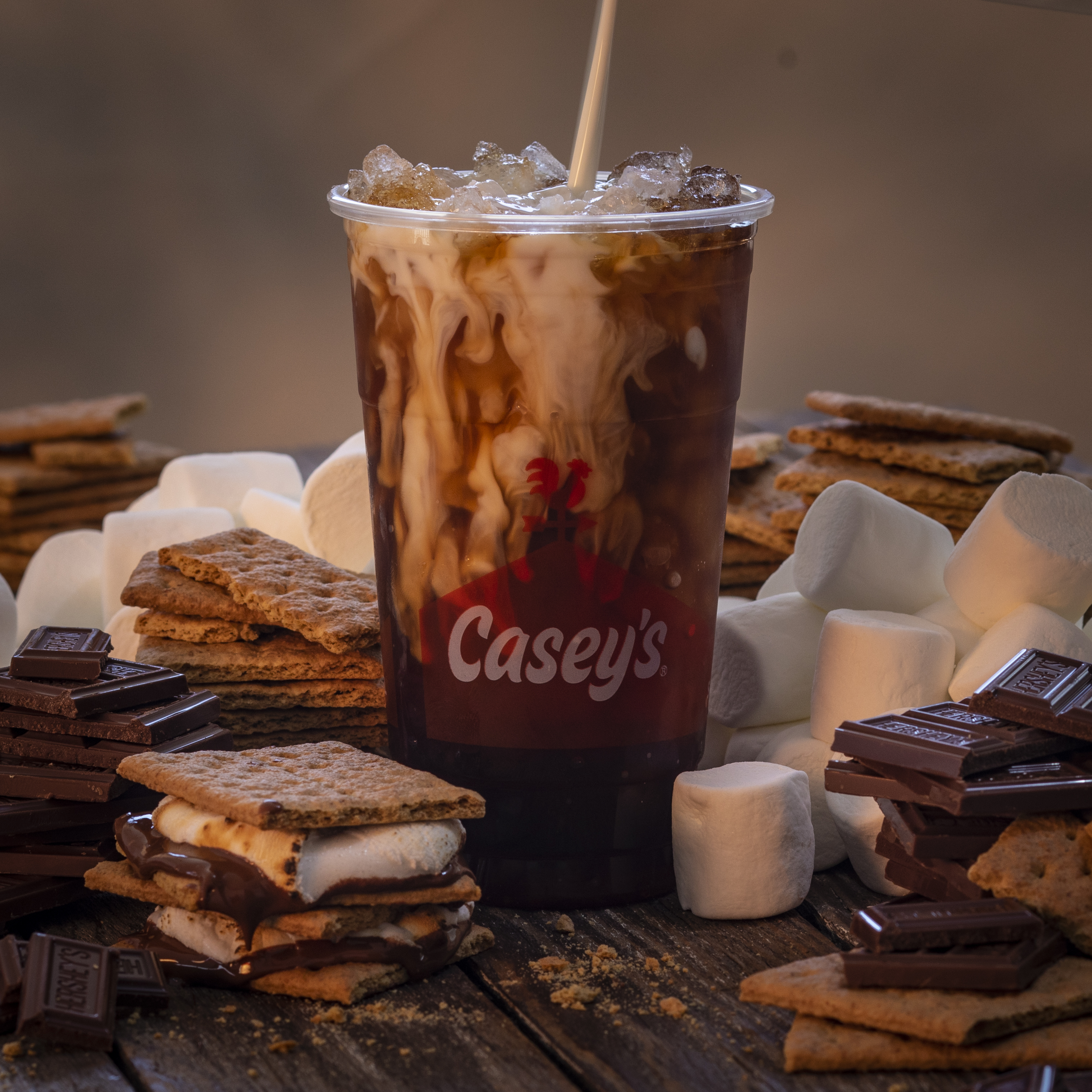 Casey's Iced S'mores Coffee with S'mores ingredients on a wooden table
