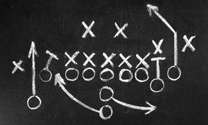 Football plays on a chalkboard