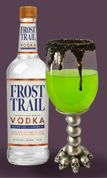 Frost Trail Vodka next to a Witches Brew Cocktail in a witch themed glass