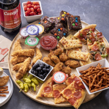 A charcuterie board made of Casey's Pizza, pretzels, Cheesy Breadsticks, and more!