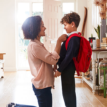 mom getting son ready for school