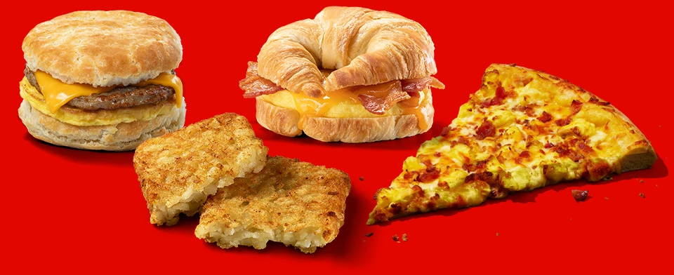 Sausage, egg and cheese bisuit, bacon, egg and cheese croissant, hashbrown and slice of bacon breakfast pizza