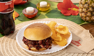 Casey's King’s Hawaiian® Brisket Sandwich on a plate on a Hawaiian themed table