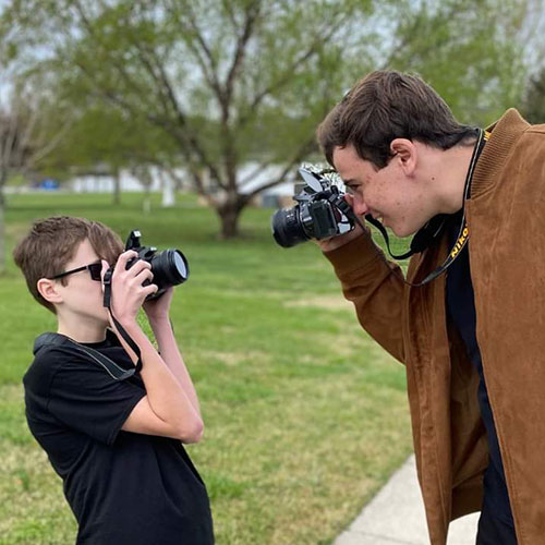 older brother taking photo of little brother