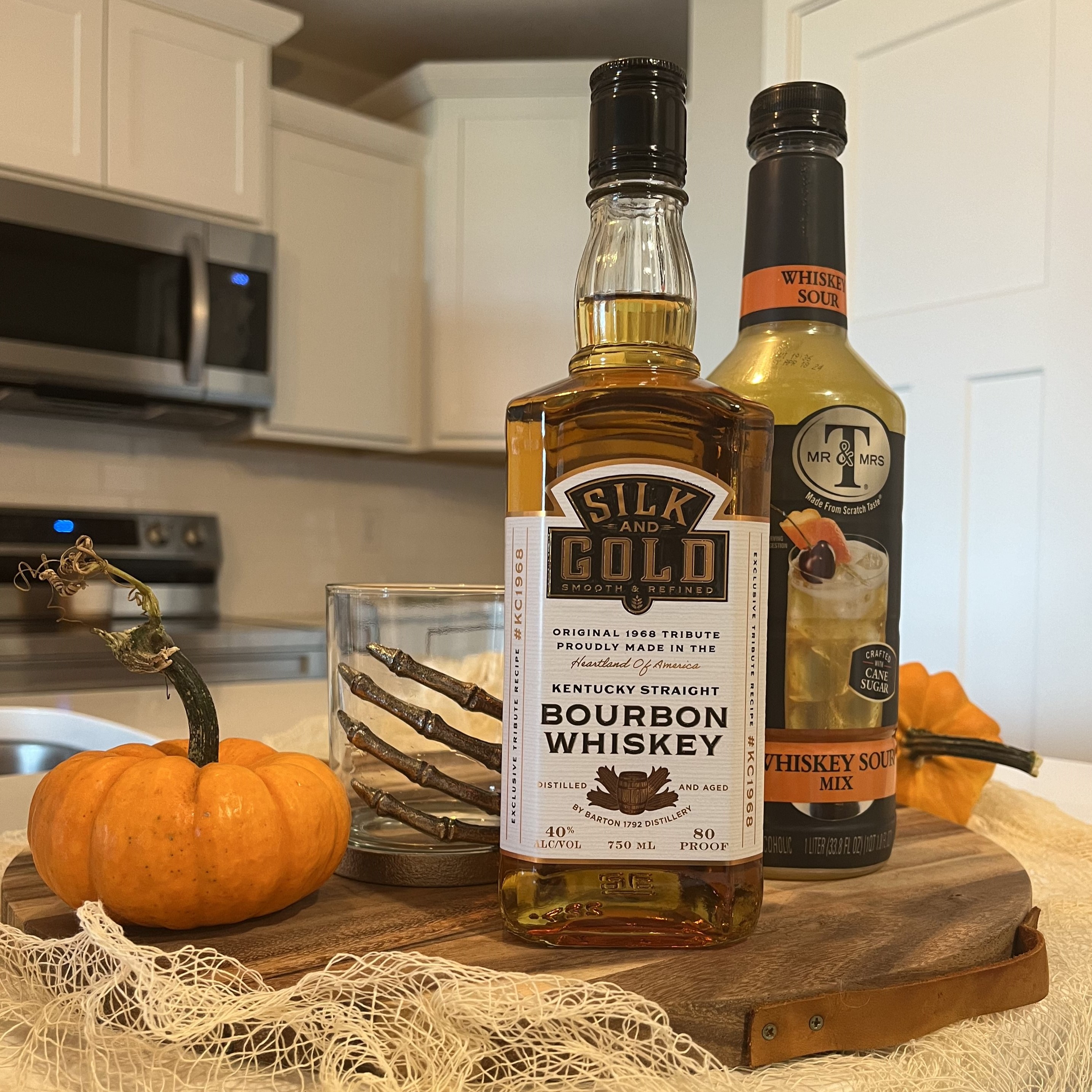 Ingredients to make a Dark & Stormy Whiskey Sour for a Halloween alcoholic drink
