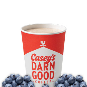Cup of hot coffee and cappucino mixed with bluerries along the bottom.