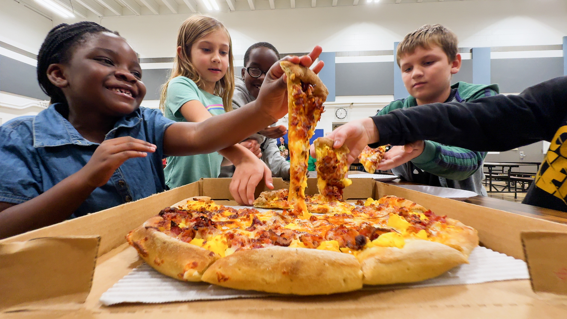 Kids eating a Casey's breakfast pizza