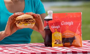 Someone having a picnic with a Casey's Chicken Sandwich, Cola, Peanuts, and Casey's Jerky