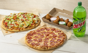 Mtn Dew 2-Liter, Pepperoni & Taco Pizzas, and Chicken Wings & sauces on a wooden table