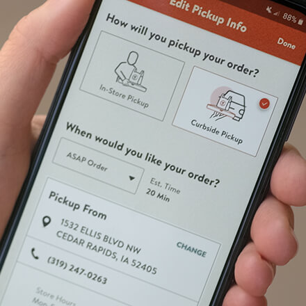 person using their phone to order curbside pickup
