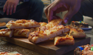 Cheesy Breadsticks and Casey's Party Brookie on a table at a football party