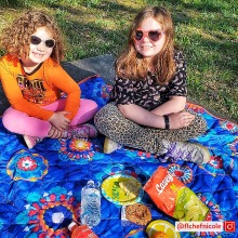 Two kids enjoying a picnic with Casey's snacks - from influencer Nicole Hood
