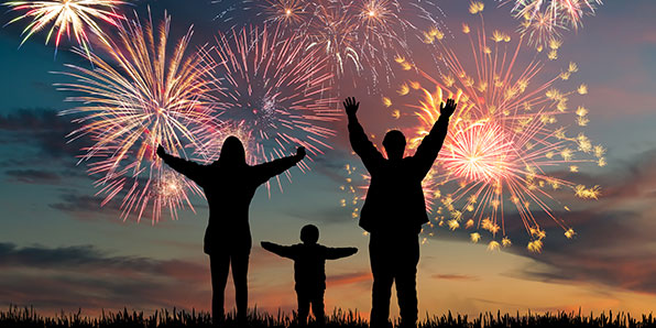 people standing looking at fireworks