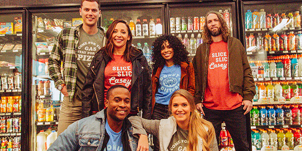 Casey's Merch: People wearing shirts in a Casey's store