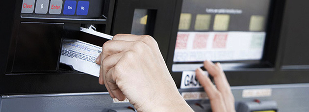 inserting credit card into gas pump